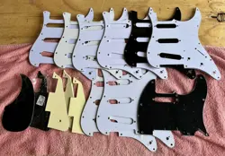 15 ASSORTED PICKGUARDS, CELLOPHANE PROTECTED AND BAG OF GUITAR PICKS