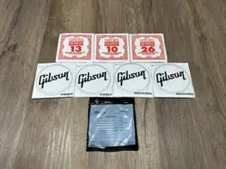 LOT OF 8 GUITAR STRINGS (ERNIE BALL, GIBSON AND DUNLOP)