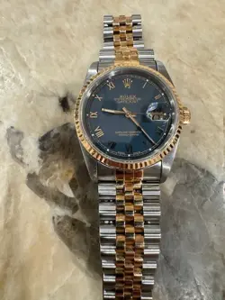 ROLEX DATEJUST WITH JUBILEE BRACELET WITH GOLD FLUTED BEZEL AND BLUE DIAL