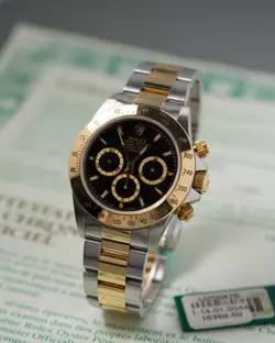ROLEX DAYTONA REF. 16523 GOLD STEEL BLACK DIAL 40MM UNPOLISHED PAPERS 1998
