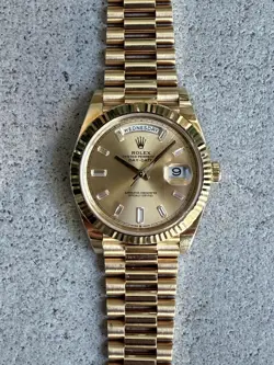 ROLEX DAY-DATE 40MM CHAMPAGNE BAGUETTE DIAMOND DIAL 18K YELLOW GOLD. REF. 228238