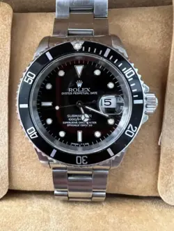Rolex Submariner R11610A w/calendar black dial boxes certificate, all booklets.