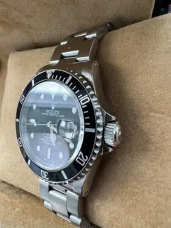Rolex Submariner R11610A w/calendar black dial boxes certificate, all booklets.