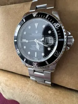 Rolex Submariner R11610A w/calendar black dial boxes certificate, all booklets.