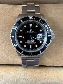 Rolex Submariner R11610A w/calendar black dial boxes certificate, all booklets.