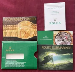 Rolex Submariner R11610A w/calendar black dial boxes certificate, all booklets.