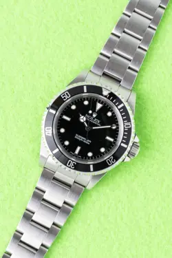 1996 ROLEX SUBMARINER 14060 WITH BOX AND PAPERS