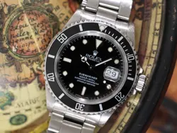 ROLEX SUBMARINER 16610 SILVER OYSTER BRACELET WITH BLACK BEZEL BOX AND PAPERS